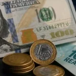 Dólar cai a R$ 5,10 e Copom corta juros para 14%